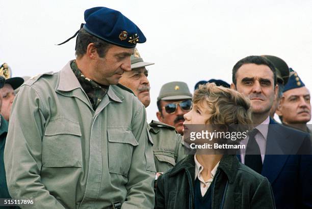 Almeira, Spain: King Juan Carlos of Spain, wearing beret, chats with his son, Crown Prince Felipe, while observing Spanish-American military...