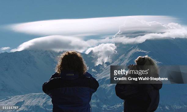 Lorraine Kells and Susan Tyler , of Tacoma, Washington, view the crater on the north side of Mount St. Helens as a steam cloud vents from behind the...