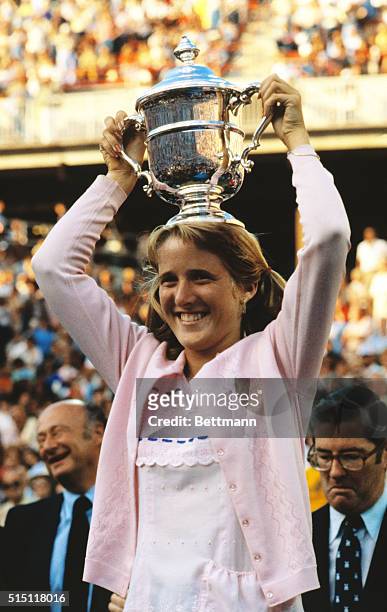 With a smile of triumph, 16-year-old California schoolgirl Tracy Austin holds her trophy after winning the United States Open tennis championship...