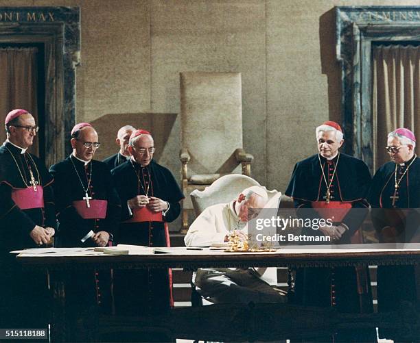 Pope John Paul II signs the new Roman Catholic Code of Canon Law. : Msgr. Bruno Fagiolo of the Vatican Secretariat; Msgr. Martinez Somal, Vatican...