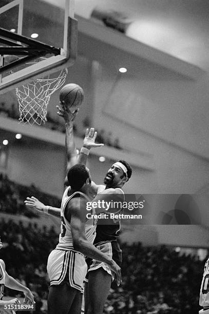 Detroit: Bob Lanier, 6 foot 11 inch superstar center for Detroit, uses his long arm to block an attempted hook by Wilt Chamberlain, 7-foot, 1-inch...