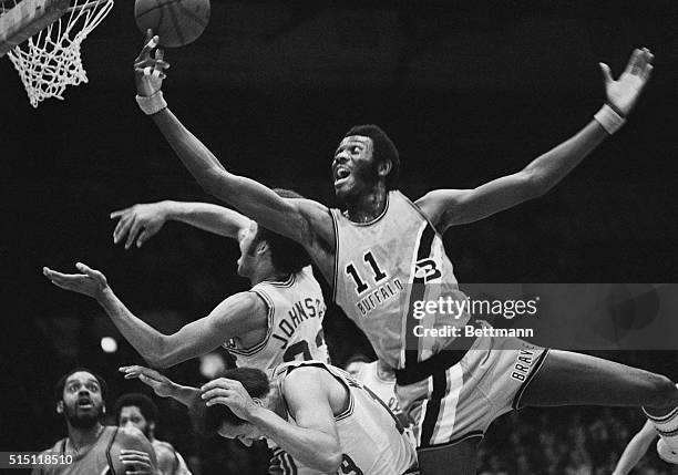 Buffalo's Bob McAdoo, goes over Cavalier's Lenny Wilkens and John Johnson to score a basket during half play here on November 3rd. The Cavaliers won...