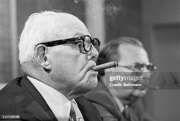 Miami: Labor leader George Meany has his cigar at the ready as he listens to a newsman's question. Meany commented on the Nixon's administration's...