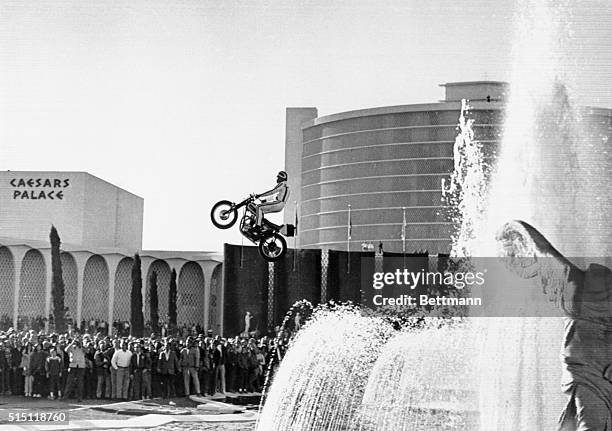 Motorcycle stunt man Evel Knievel jumping over the fountain at Caesars Palace in Las Vegas, Nevada December 31, 1967. He made the jump, but crashed...