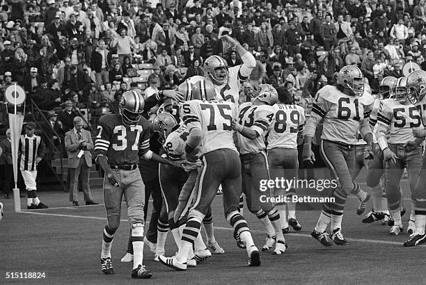 Dallas Cowboys' mob Ron Sellers after he caught the winning touchdown pass thrown by quarterback Roger Staubach during the last minute of play...