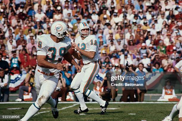 Dolphins' Bob Griese with ball during first quarter action. Dolphins' Larry Csonka can be seen in front of him.
