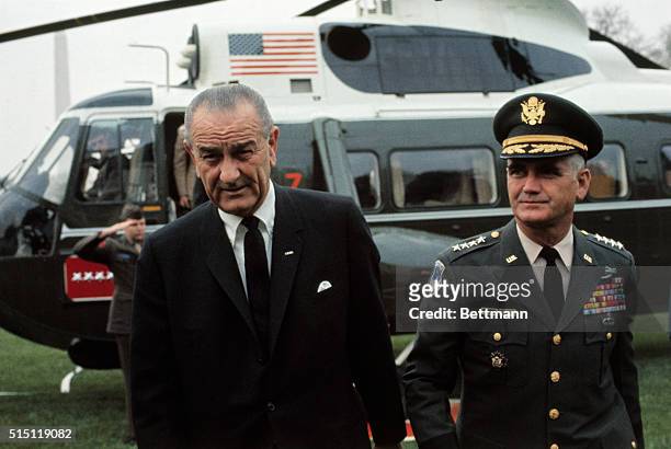 President Lyndon B. Johnson, left, and Gen. William Westmoreland leaving helicopter.