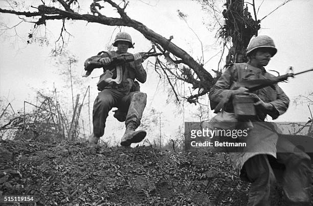 Members of the 3rd brigade, First Air Cavalry, jump into a ditch after Communist troops ambushed them as they moved down Highway One towards Hue.