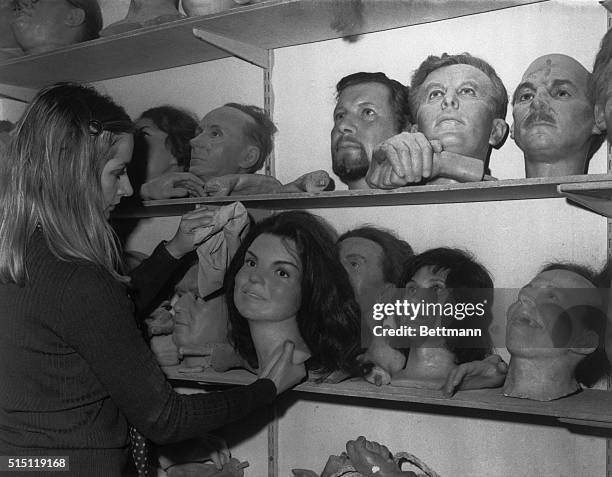 Head" of Mrs. Jacqueline Kennedy is dusted in a storeroom that is a kind of "death row" at Madame Tussad's waxworks in London. "Heads" of important...