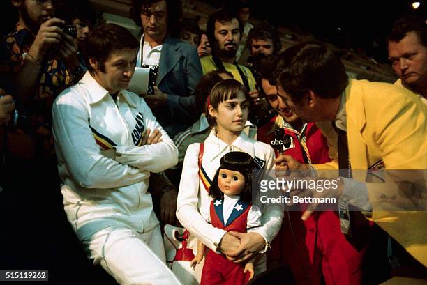Montreal, Canada: Nadia Comaneci holds onto her doll tightly after the 14-year-old superstar captured a gold medal and the hearts of the spectators...