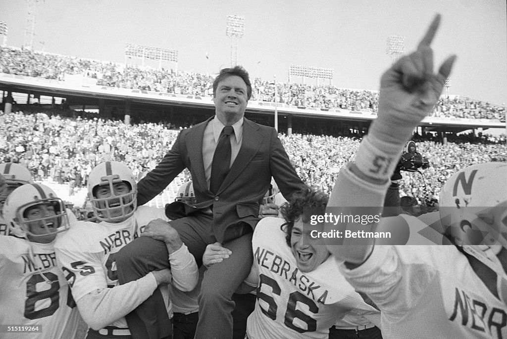 Coach Tom Osborne Being Carried by His Team After Football Game Win