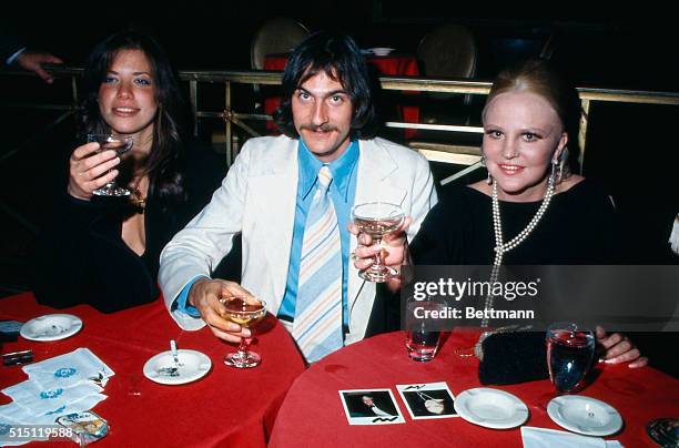 Singer Peggy Lee seated at table with singers James Taylor and his wife Carly Simon at the Waldorf-Astoria Hotel.