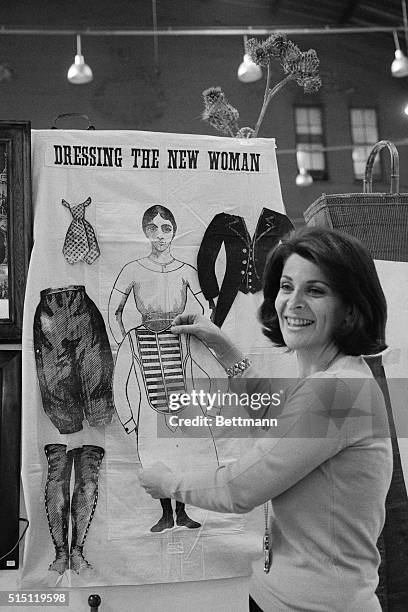 New York: At her booth at the National Arts and Antiques Festival, Mrs. Ann Phillips shows a suffrage party game from the 1880's Object of the game...