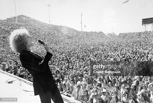 Phoenix, Arizona: Barbra Streisand, actress, shown performing to young crowd at Phoenix Tempe Football Stadium in movie A Star is Born.