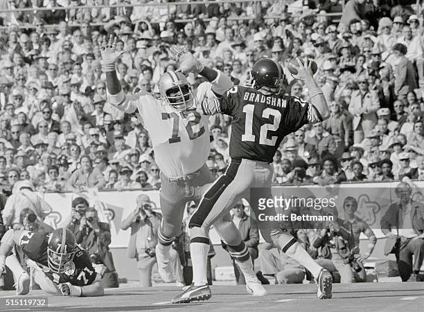 Super Bowl...1976. Pitts Steeler QB Terry Bradshaw, about to pass as Dallas Cowboys' "Too Tall" Jones jumps up to pounce on the quarterback.