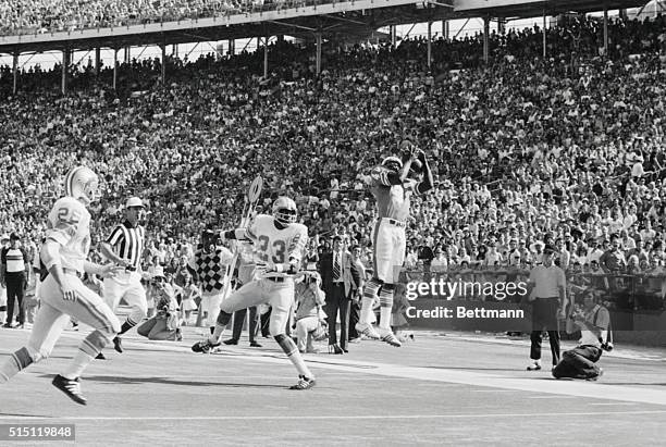 Paul Warfield of the Miami Dolphins catches Levi Johnson of Detroit, , flat-footed here, as Warfield hauls in a touchdown pass on the Dolphins' first...