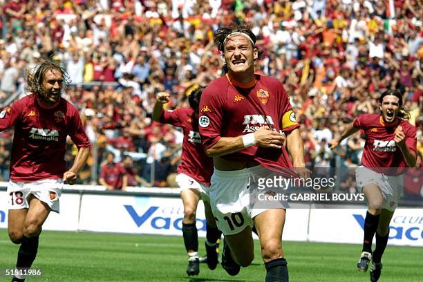 Roma's captain Francesco Totti jubilates after scoring the first goal against Parma during the last day of the First Italian League at Rome's Olympic...
