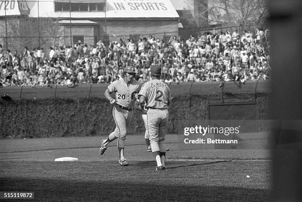 Mike Schmidt of Philadelphia is congratulated by 3rd base coach Billy DeMars after hitting a home run with one man on in the 5th inning at Wrigley...