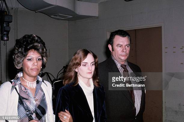 Patty Hearst , accompanied by matron, leaves San Mateo County Jail here en route to Federal Court in San Francisco.