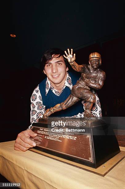 Penn State star John Capelletti stands with the Heisman Trophy here 12/4 after winning the award symbolic of the nation's outstanding college...