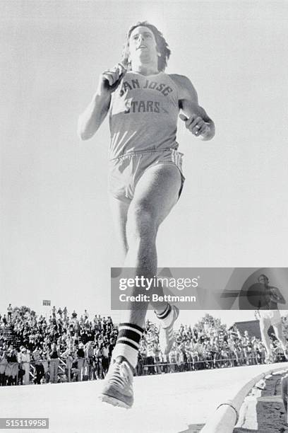 Eugene, Oregon: : Bruce Jenner, San Jose star, has both feet off the ground as he rounds the turn for finish line in the 1,500 meter event 6/26, in...