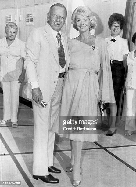 Palm Springs, California: Frank Sinatra and Barbara Marx pose for photographers before their wedding reception at the Sinatra home. They were married...