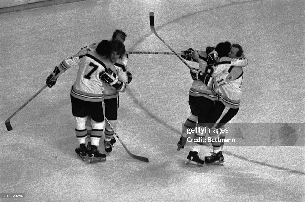 Players Celebrating on Ice After Win