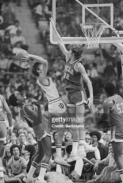S Bill Walton blocks the basket as Indiana's Steve Green tries to shoot in the second half of the UCLA-Indiana NCAA semifinal game, 3/24. Green is...