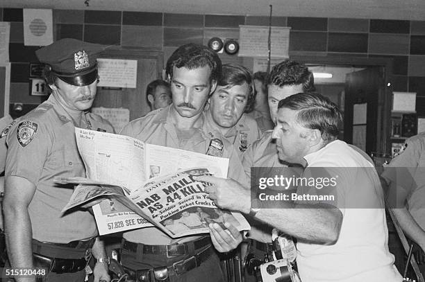 At the Manhattan Police Headquarters, some of the hundreds of policemen involved in the "Son of Sam" manhunt read about his capture on August 11th,...