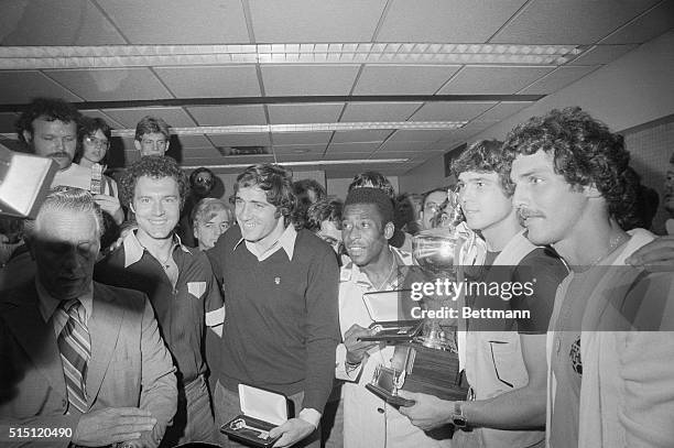 Queens, New York, New York: Members of the New York Cosmos, winners of the 1977 NASL Championship, pose with their trophy and keys to New York City...