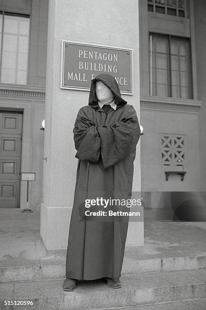 Washington: This demonstrator, clad I a black robe with a stocking covering his face gives the appearance of "death" as he stand watch in front of...