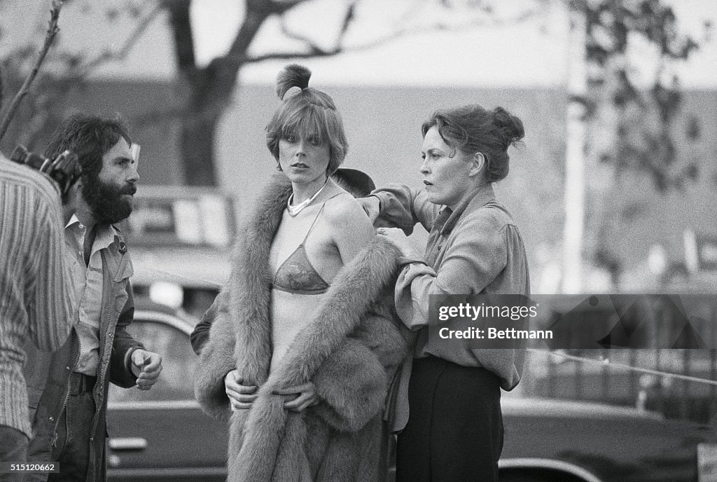 Faye Dunaway Assisting Model with Fur Coat