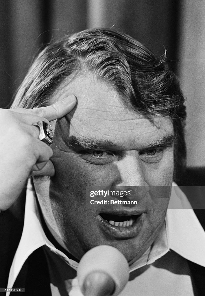 John Madden with Finger on Head