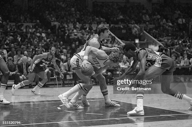 New York Knicks Glen Gondrezick with ball in hand try's to drive past 76'ers Harvey Catchings in first period of play here 12/25 at Madison Square...