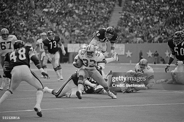 Tony Dorset springs to a Dallas Cowboys touchdown in the 3rd quarter as Chicago Bears Doug Plank is sent flying by a block at the line of scrimmage.