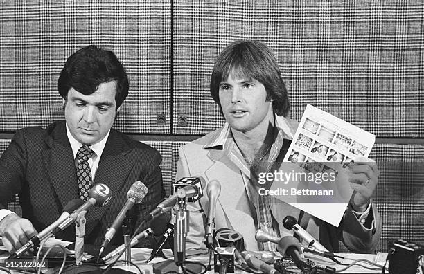 San Francisco, California: Olympic decathlon champion, Bruce Jenner, displays a sheet of him promoting a cereal called Wheaties at a news conference...