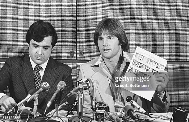 San Francisco, California: Olympic decathlon champion, Bruce Jenner, displays a sheet of him promoting a cereal called Wheaties at a news conference...
