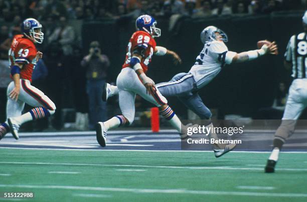 Receiver Butch Johnson of the Dallas Cowboys reaches out to catch a touchdown pass during Superbowl action against the Denver Broncos.