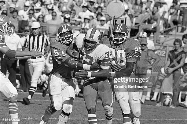 Denver Broncos tacklers Bob Swenson and Louis Wright stop Buffalo Bills star running back, O.J. Simpson, for a 3-yard loss on this 3rd quarter play....