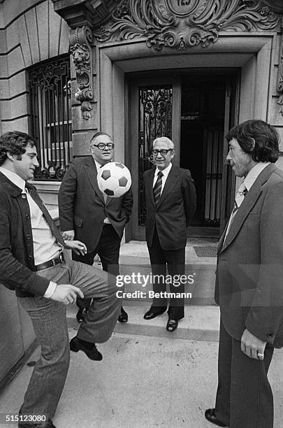 Giorgio Chinaglia and Gordon Banks kick around soccer ball as England's Ambassador to the United Nations. Piero Vinci watch in front of Ambassador...