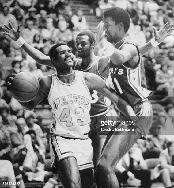 Indiana Pacers guard Earl Tatum is double teamed by 76er teammates Joe Bryant and Caldwell Jones during a game at the Market Square Arena in...
