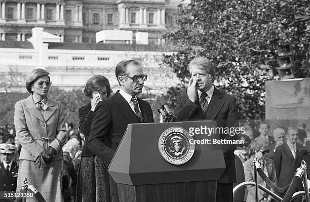 Washington, DC- President Carter and the First Lady wipe their eyes from the gas fumes that moved onto the White House grounds from an anti-Shah...