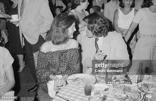 Jackie Onassis and Jann Wenner of Rolling Stone magazine share table at the Oyster Bar in Grand Central Station. The party they attended was for the...