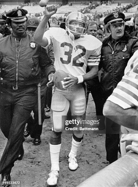 San Francisco Running Back, O.J. Simpson, walks off the playing field for the last time and acknowledges the crowds reaction. Simpson completed his...