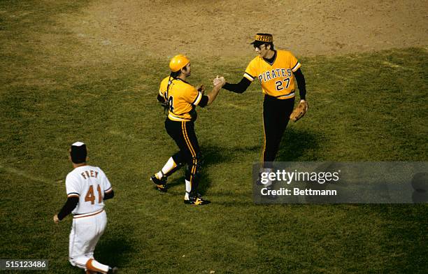 Baltimore: Pirate catcher Ed Ott and pitcher Kent Tekulver shake hands after the Pirates won the 6th game of the series.