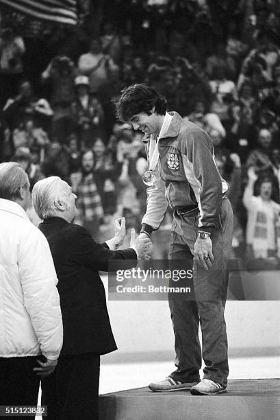 Lord Killanin, president of the International Olympic committee, congratulates American hockey team goalie Jim Craig after presenting him with a gold...