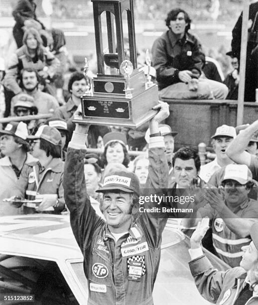 Daytona Beach, Florida: Victorious Bobby Allison holds his trophy, winning the Daytona 500, the richest race for stock cars.