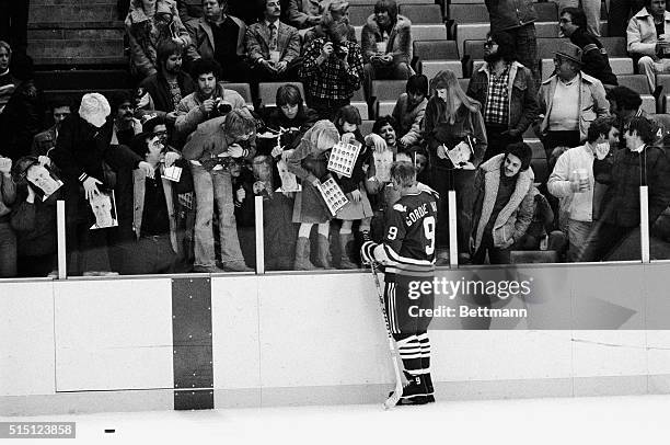 Hartford Whalers' Gordie Howe is shown giving his autographs to fans following a game with the Detroit Red Wings.