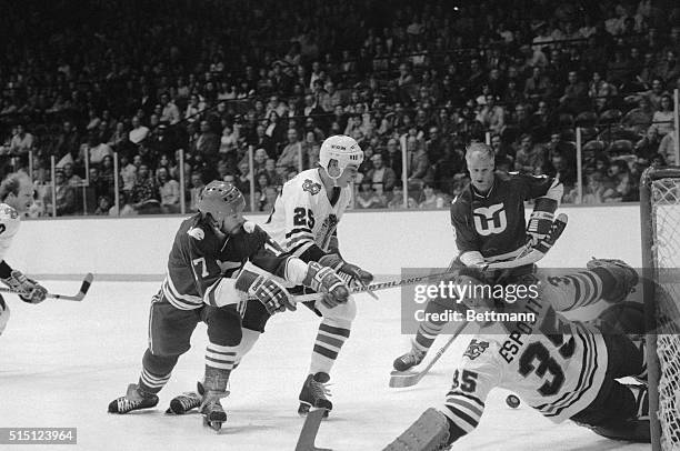 Hartford Whalers' Gordie Howe beats Black Hawks' goalie Tony Esposito in the first period of game 11/11. Howe scored again in the 3rd period to lift...