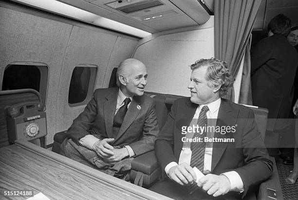 Sioux City, IA- Television comedy producer Norman Lear gets a laugh 12/7 from Senator Edward Kennedy, as the two talk aboard Kennedy's campaign plane...